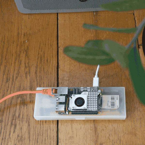 raspberry pi on a wooden floor. cables connected
